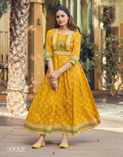 Alluring Mustard Yellow Heavy Reyon With Foil Print Gown